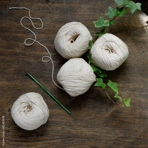 Ball of cream and blue yarn with crochet hook