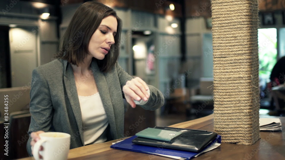 Young businesswoman finishing drinking coffee and leaving Young businesswoman finishing drinking coffee and leaving