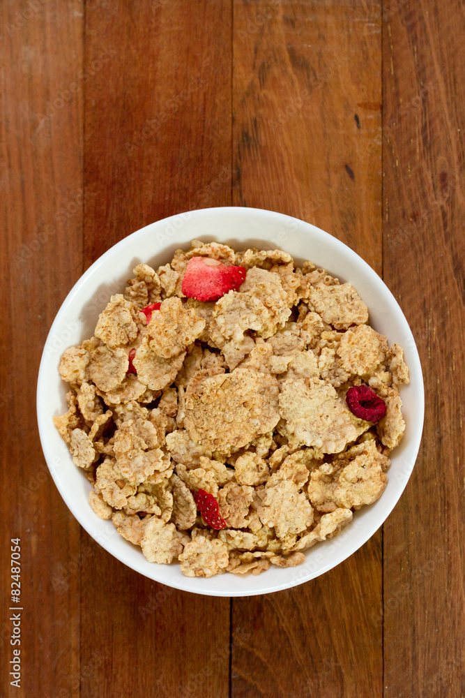 cereals with dry fruits in white bowl on brown background cereals with dry fruits in white bowl on brown background