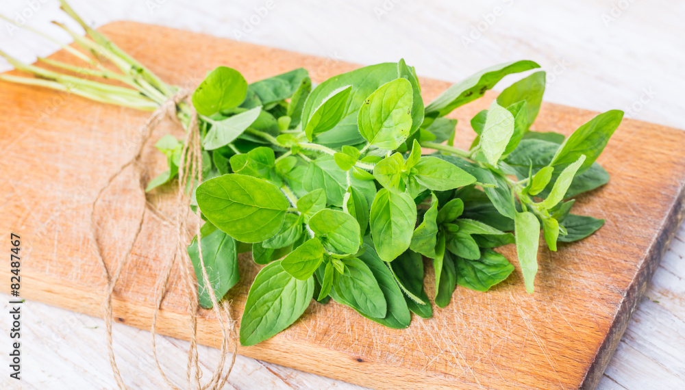 Fototapeta premium Fresh oregano on the kitchen board