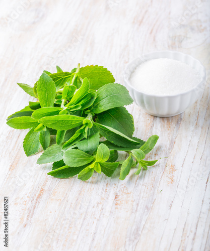 Fresh stevia leaves and bowl with sugar