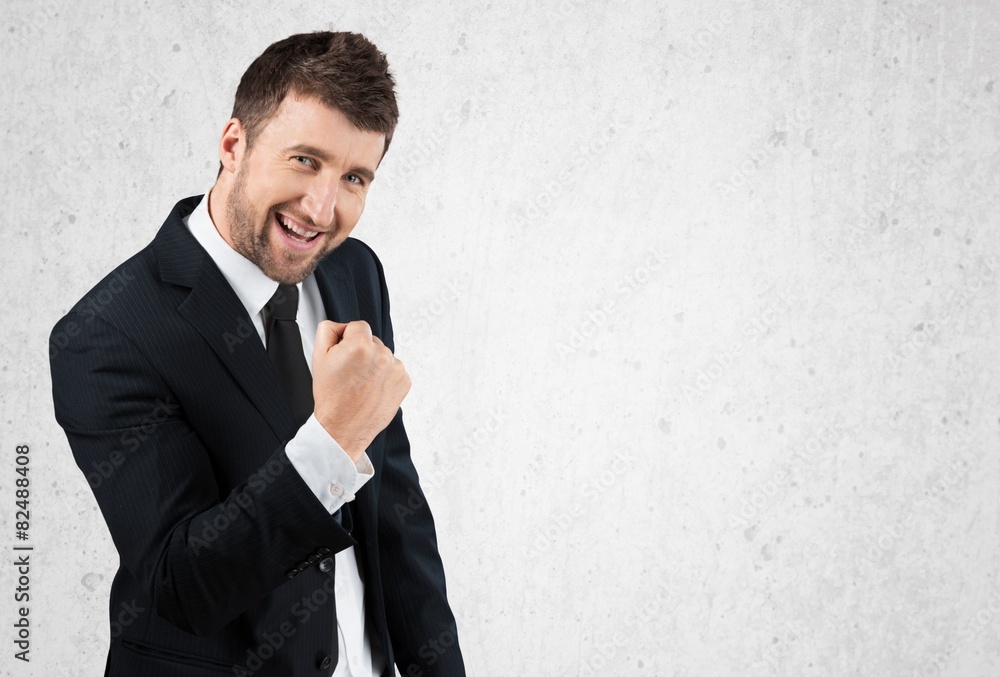 Success. Happy successful gesturing businessman at office Success. Happy successful gesturing businessman at office