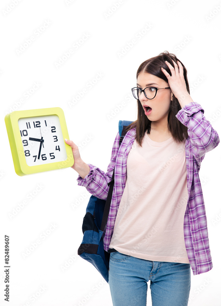 Surprised young female student looking on clock Surprised young female student looking on clock