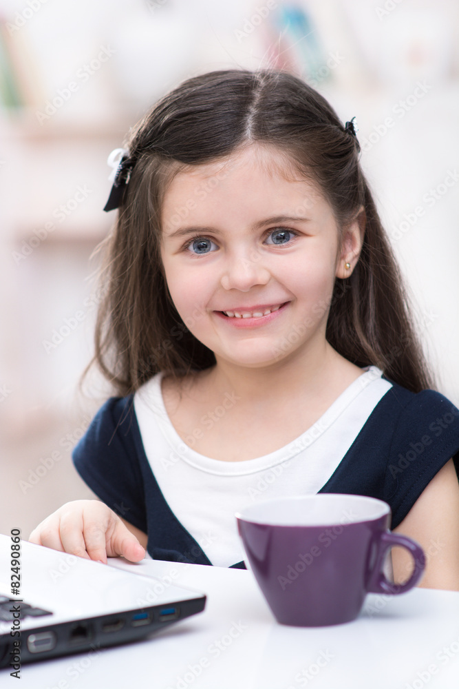 Little dark-haired girl with laptop Little dark-haired girl with laptop