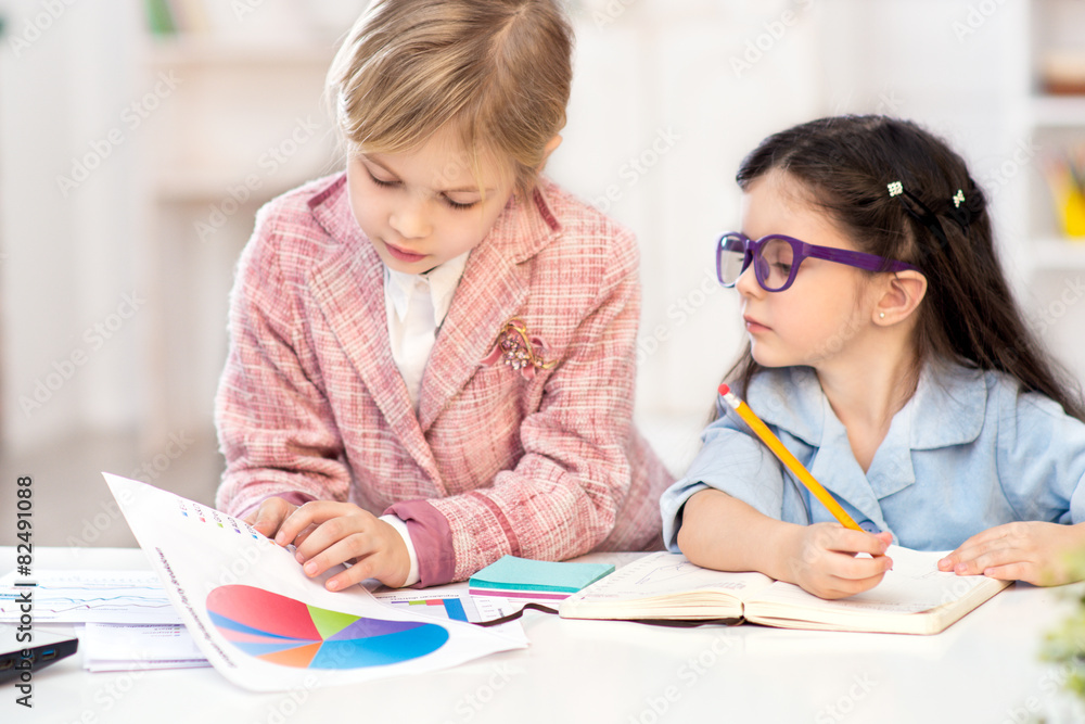 Two little cute girls playing role of business women Two little cute girls playing role of business women