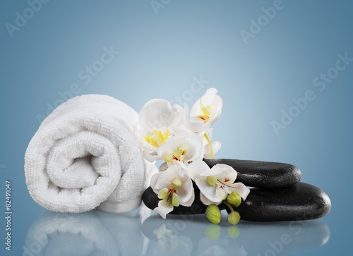 Spa Treatment. Towel, gladiola and pebbles for massage