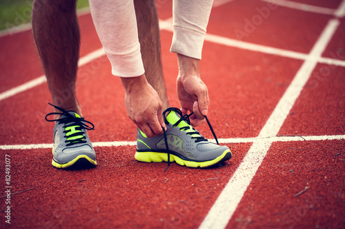 Tying shoes before run on the racetrack