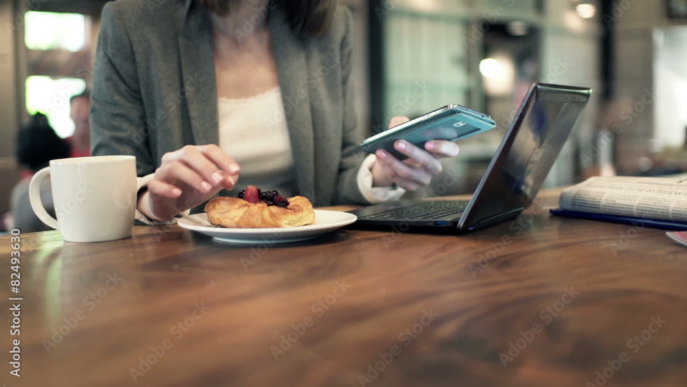Businesswoman hands with smartphone eating croissant in cafe
Businesswoman hands with smartphone eating croissant in cafe