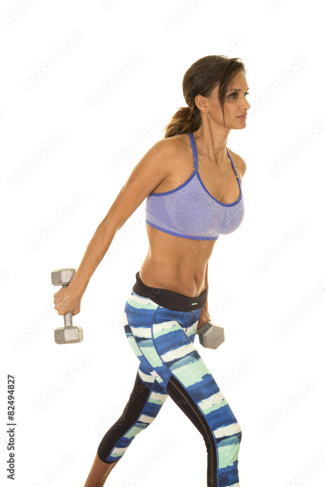 woman in blue fitness outfit extend weight back woman in blue fitness outfit extend weight back