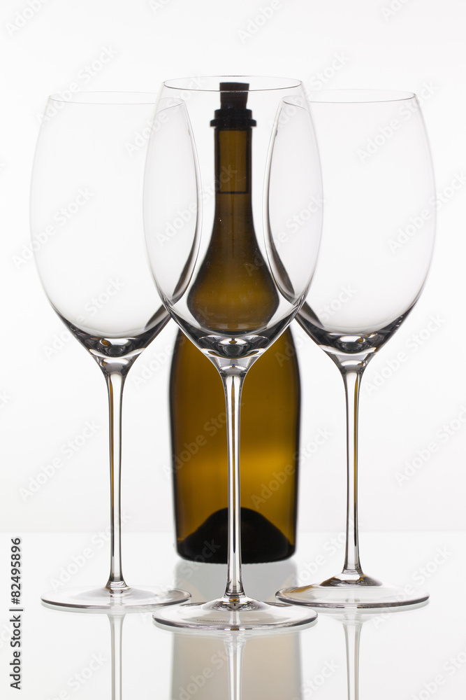 Three empty glasses of wine and brown bottle Three empty glasses of wine and brown bottle