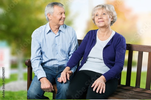 Senior Adult. Senior Couple Sitting On A Park Bench