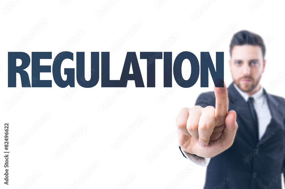 Business man pointing the text: Regulation Business man pointing the text: Regulation