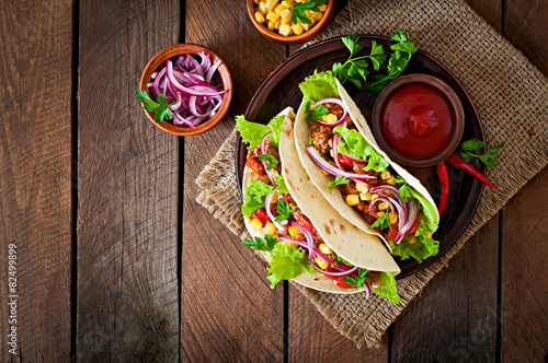 Mexican tacos with meat, vegetables and red onion