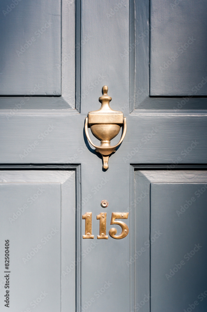 Obraz premium Door number one hundred and fifteen and knocker vignette look