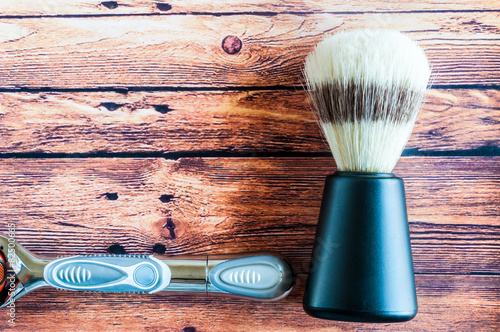 Old shaving brush with razor isolated photo