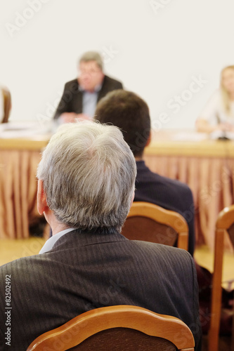The audience listens to the acting in a conference hall