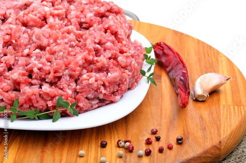minced meat with pepper, thyme and garlic on cutting board isola