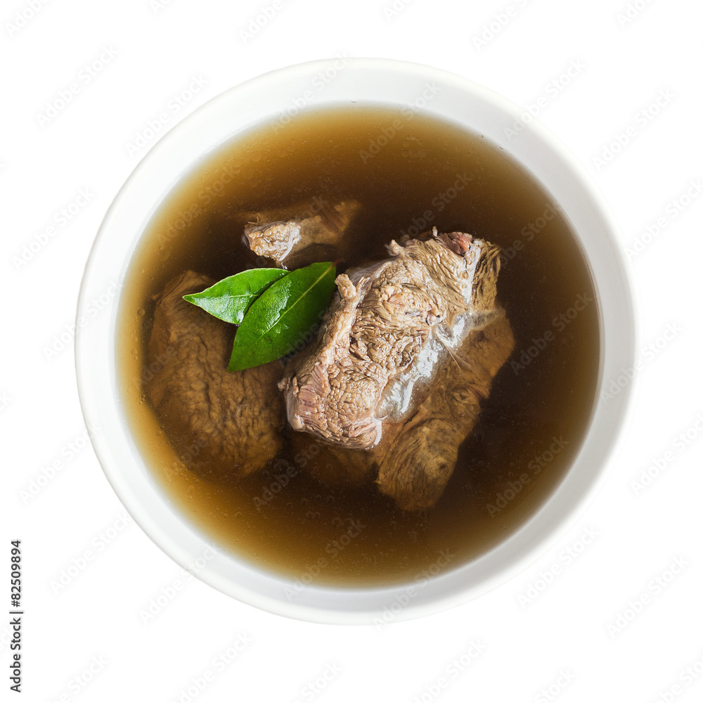 Beef broth with meat in a white bowl, isolated over white Beef broth with meat in a white bowl, isolated over white