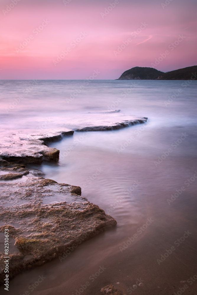 Baratti bay, headland hill, rocks and sea on sunset. Tuscany, It Baratti bay, headland hill, rocks and sea on sunset. Tuscany, It