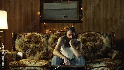 MS TD Lonely man watching television on living room sofa/ Orem, Utah, USA photo