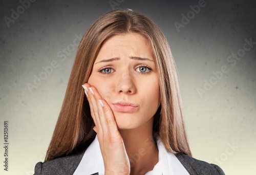 Abscess. Closeup portrait young woman with sensitive tooth ache photo