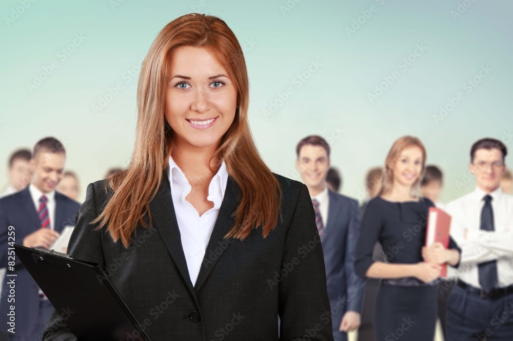 Business. Happy businesswoman with colleagues in the background Business. Happy businesswoman with colleagues in the background