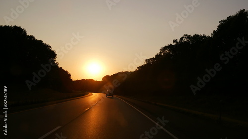 time lapse movie of a automoblie point of view as it races down a highway at dusk photo