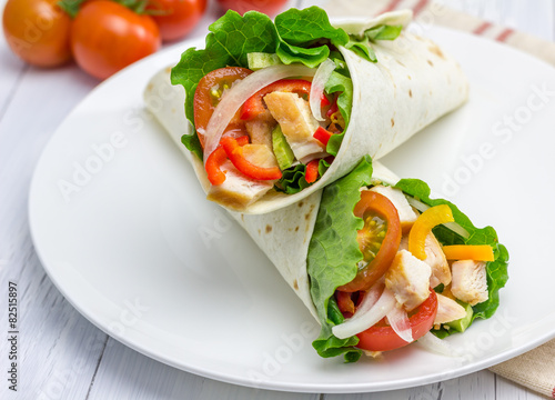 Tortilla wraps with roasted chicken, vegetables and sauce
