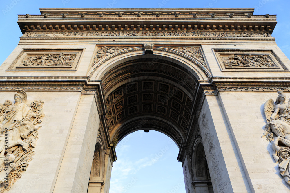 Arc de Triomphe paris france famous landmark monument looking up upwards view blue sky background photo