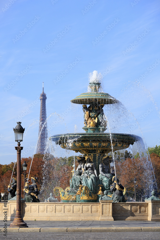 Famous fountain in Place de la Concorde Paris France with eiffel tower in the distance photo vertical
