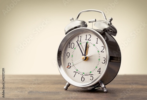 Clock. Vintage background with retro alarm clock on table