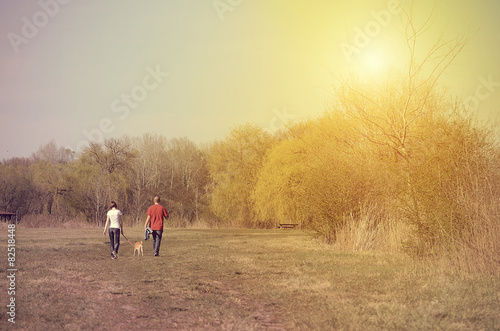 Young couple walking on park. Vintage view