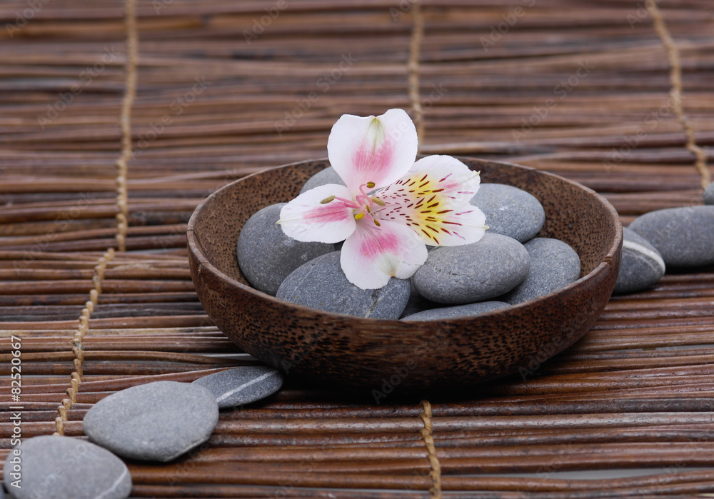 gorgeous orchid with gray stones in wooden bowl on mat gorgeous orchid with gray stones in wooden bowl on mat