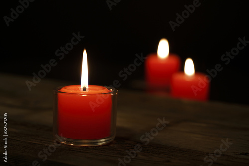 Hope illuminatesThree candles on the old wooden table