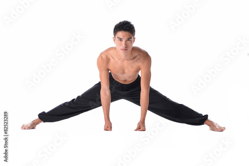 Handsome active man doing yoga fitness poses.