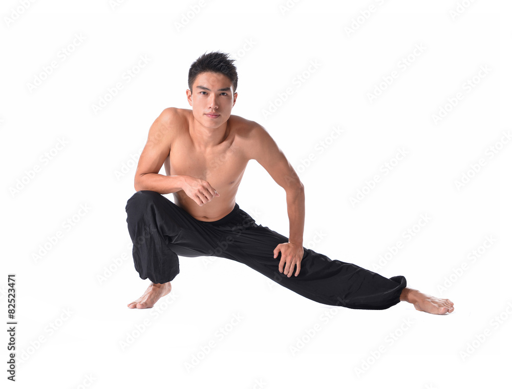 young fitness man sitting and making stretching exercises