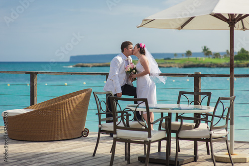 young loving couple on tropical sea background - wedding on