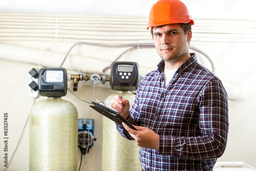 male worker inspecting work of industrial equipment male worker inspecting work of industrial equipment