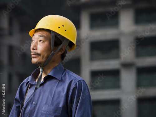 Thoughtful construction worker at construction site