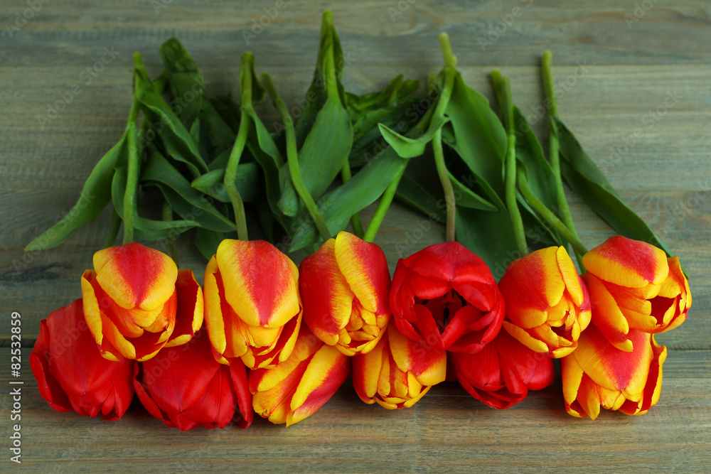 Fresh beautiful tulips on a wooden background Fresh beautiful tulips on a wooden background