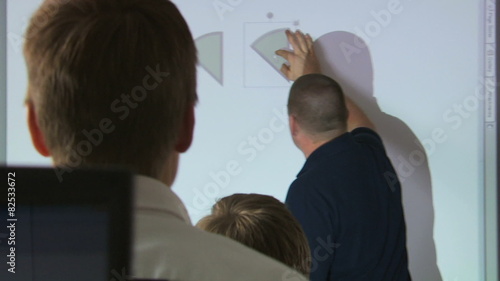 teacher demonstrating geometry with an overhead projector photo