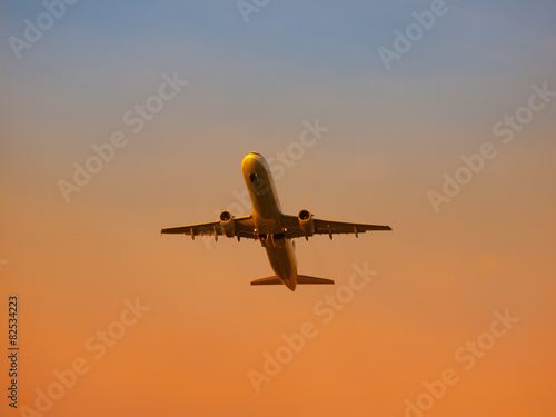 Airplane leaving airport at the sunset