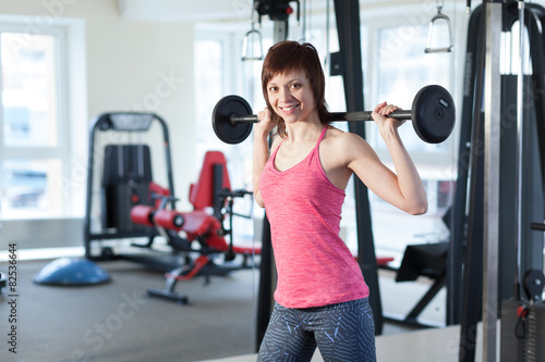 Woman with barbell at the gym