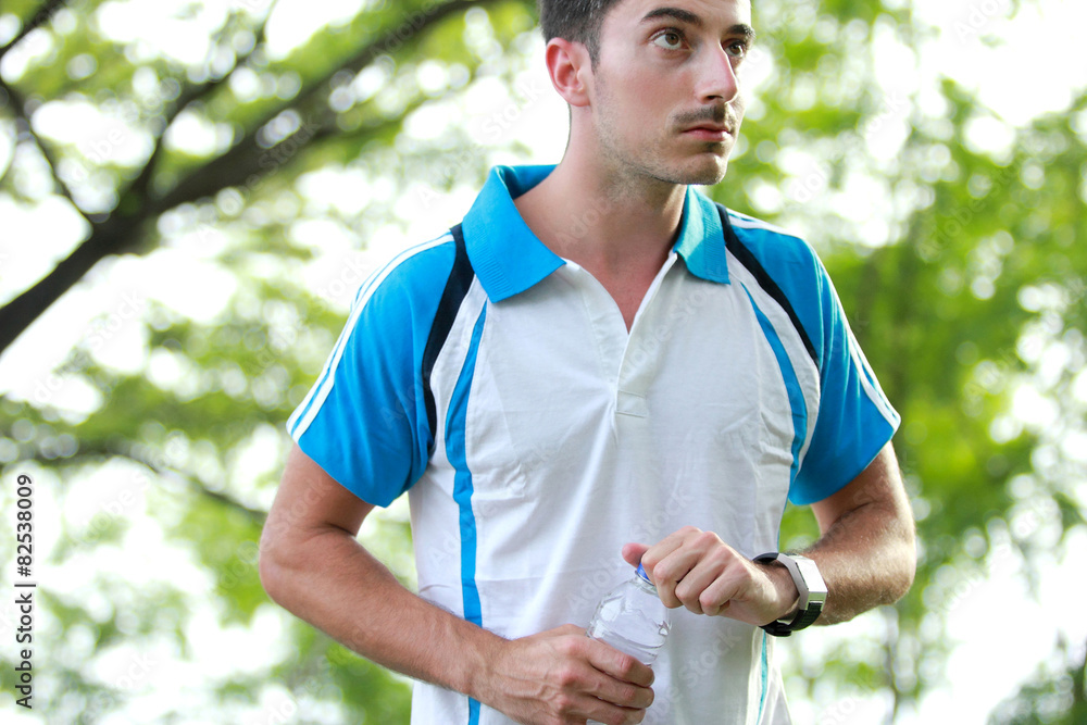sporty male runner taking a break after tired running sporty male runner taking a break after tired running