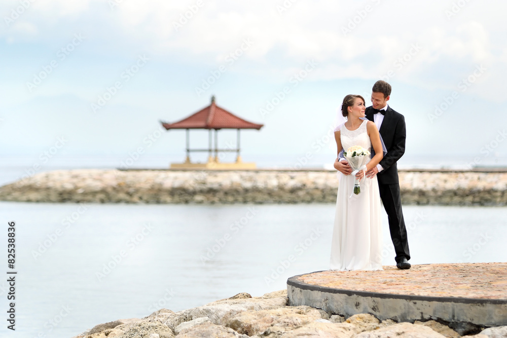 groom embracing his bride