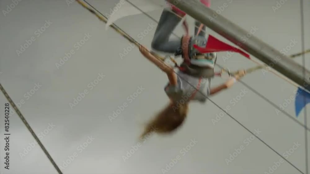 Medium panning shot of girl on bungee trampoline at amusement park / Salt Lake City, Utah, United States Medium panning shot of girl on bungee trampoline at amusement park / Salt Lake City, Utah, United States
