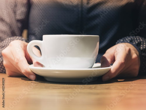 Coffee cup holding in woman hand close up