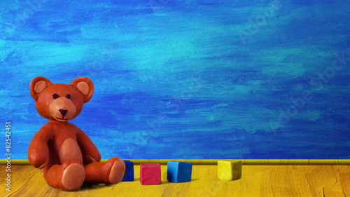 Children's room with aircraft, bear, cubes and peg-top.