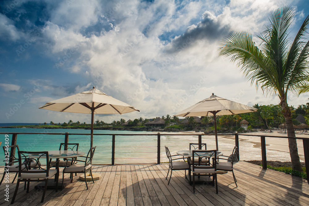 Outdoor restaurant at the beach. Cafe on the beach, ocean and