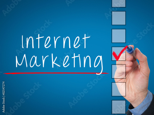 Business hand writing internet marketing and check listing task